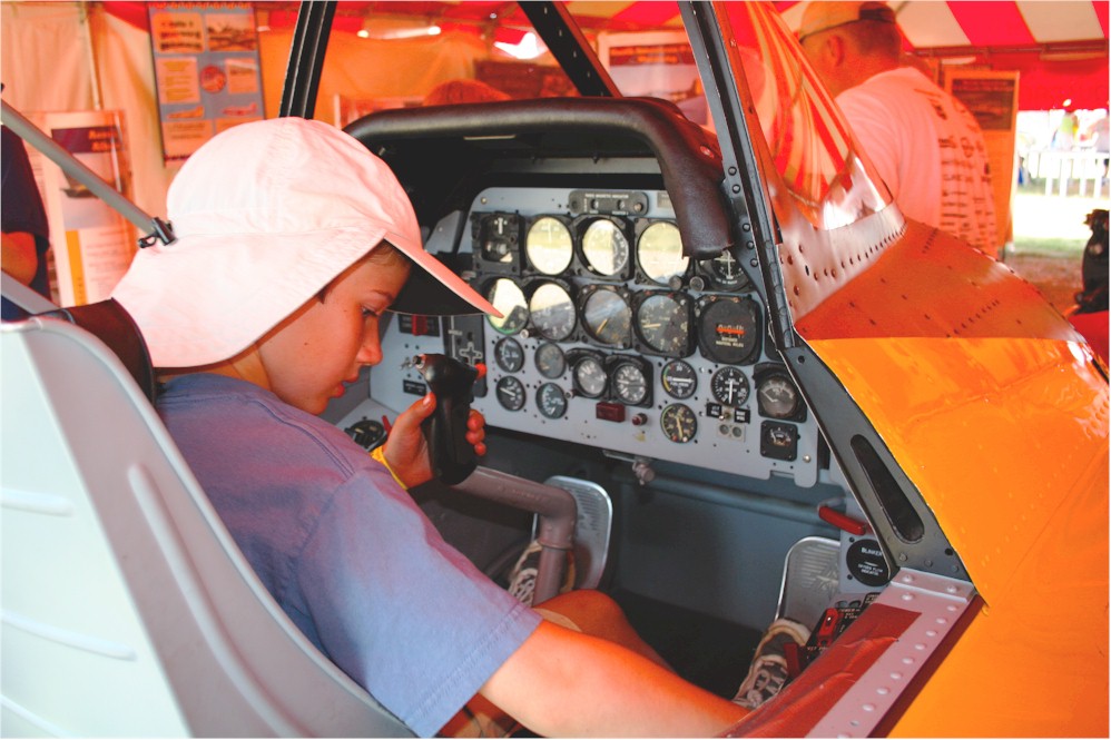 Kid in T-28 cockpit procedures trainer